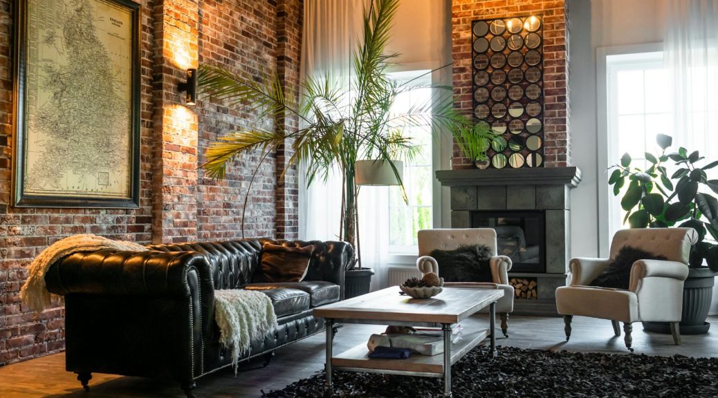 Living Room With Green Plants and Brown Sofa Chairs