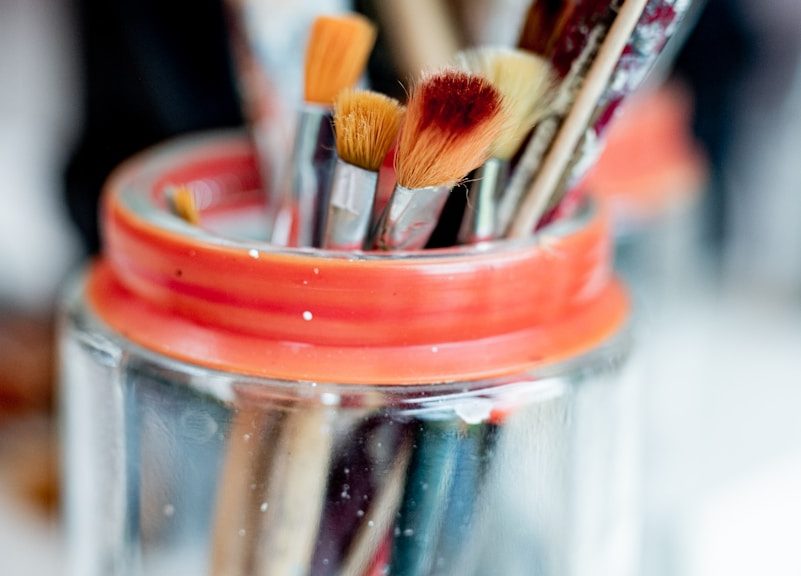 brown wooden brush in clear glass jar