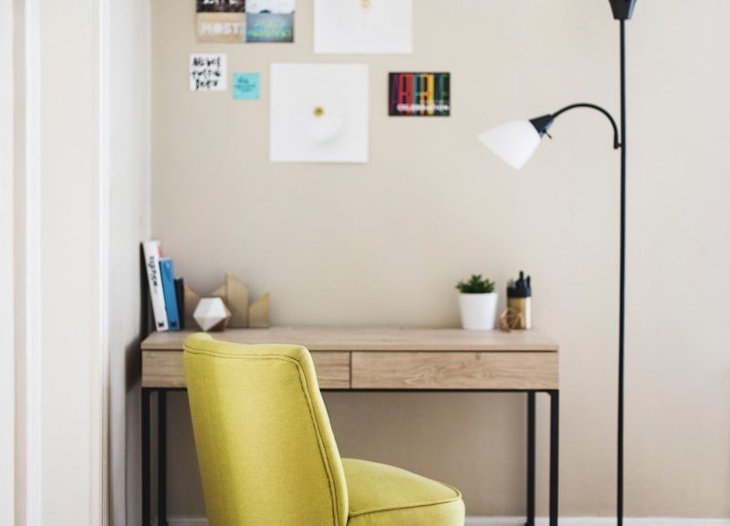 black 2-light torchiere beside brown wooden-top desk with black steel frame